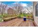 The spacious wooden deck features built-in benches, perfect for enjoying the serene backyard and outdoor living at 7002 Oakbay Cir, Noblesville, IN 46062