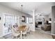 Bright dining area features tile floors, patio access, and open view of the living room at 7002 Oakbay Cir, Noblesville, IN 46062