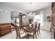 Formal dining room with an elegant chandelier, large window, and staircase view at 7002 Oakbay Cir, Noblesville, IN 46062