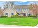 Charming two-story home featuring blue shutters, manicured lawn, and lovely landscaping at 7002 Oakbay Cir, Noblesville, IN 46062