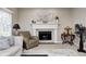 Close-up of living room fireplace with mantle, comfortable seating, and decorative rug at 7002 Oakbay Cir, Noblesville, IN 46062