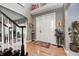 Inviting foyer with hardwood floors, elegant front door with sidelights, and neutral paint at 7002 Oakbay Cir, Noblesville, IN 46062