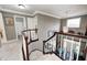 Upper-level hallway showcasing neutral walls and access to a bathroom with shower/tub at 7002 Oakbay Cir, Noblesville, IN 46062