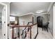 Second floor hallway showing stairs leading to the main floor and a dark wood cabinet at 7002 Oakbay Cir, Noblesville, IN 46062