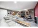 Finished basement Gathering room boasts plush seating, a large entertainment center, and a neutral carpet at 7002 Oakbay Cir, Noblesville, IN 46062