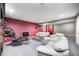 Finished basement Gathering room boasts plush seating, modern chair, and adjacent bonus room at 7002 Oakbay Cir, Noblesville, IN 46062