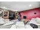 Finished basement Gathering room boasts plush seating, a large entertainment center, and movie-themed decorations at 7002 Oakbay Cir, Noblesville, IN 46062