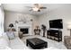 Comfortable living room features a fireplace, ceiling fan, and a cozy seating arrangement at 7002 Oakbay Cir, Noblesville, IN 46062