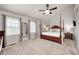 Spacious primary bedroom with a large bed, carpeted floors, and natural light from multiple windows at 7002 Oakbay Cir, Noblesville, IN 46062