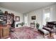Cozy home office with bookshelves, comfortable seating, and a large patterned rug at 7002 Oakbay Cir, Noblesville, IN 46062