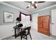 Home office with a desk, chair, wood cabinet, and natural light from a large window at 7002 Oakbay Cir, Noblesville, IN 46062