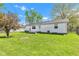 Well-maintained backyard featuring a white house with a lush lawn and a concrete patio perfect for outdoor living at 720 Danielle Rd, Lebanon, IN 46052