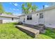 Backyard view showcasing the patio and access to the white home, surrounded by a well-maintained lawn at 720 Danielle Rd, Lebanon, IN 46052