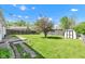 Large backyard featuring lush lawn and storage shed, ready for entertainment or relaxation at 720 Danielle Rd, Lebanon, IN 46052