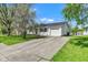 Charming single-story home with a driveway and a garage, surrounded by a well-manicured lawn and mature trees at 720 Danielle Rd, Lebanon, IN 46052
