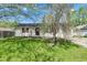 Charming home featuring a well-maintained lawn and a vibrant flowering tree in the front yard at 720 Danielle Rd, Lebanon, IN 46052