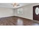 Bright living room boasting dark wood floors, a window with blinds, and a ceiling fan at 720 Danielle Rd, Lebanon, IN 46052