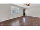 Inviting living room with dark wood floors, large window, and ceiling fan, offering a comfortable space at 720 Danielle Rd, Lebanon, IN 46052