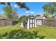 Backyard featuring a small shed, surrounded by a well-kept lawn and a secure chain-link fence at 720 Danielle Rd, Lebanon, IN 46052
