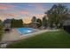 Backyard features an in-ground pool, lounge seating, and a charming fire pit area at 7259 Josiah Ct, Indianapolis, IN 46259