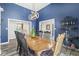 Charming dining room with blue walls, a wooden table, and comfortable seating for Gathering gatherings at 7259 Josiah Ct, Indianapolis, IN 46259