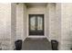 Elegant entryway featuring double doors, brick surround, and decorative planters, creating a welcoming entrance at 7259 Josiah Ct, Indianapolis, IN 46259