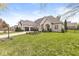 Lovely home with a lush green lawn, a long driveway, a three-car garage, and an inviting entryway at 7259 Josiah Ct, Indianapolis, IN 46259