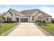 Stunning brick home with a well-manicured lawn and a long driveway leading to a three-car garage at 7259 Josiah Ct, Indianapolis, IN 46259