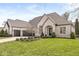Elegant brick home featuring manicured landscaping, a three-car garage, and a charming front entrance at 7259 Josiah Ct, Indianapolis, IN 46259