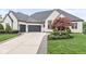 Elegant white brick home with a curved driveway, three-car garage, and beautiful landscaping at 7259 Josiah Ct, Indianapolis, IN 46259