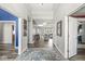 Inviting foyer with wood floors, neutral walls, decorative rug, and doorways leading to various living spaces at 7259 Josiah Ct, Indianapolis, IN 46259