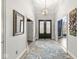 Grand foyer with high ceilings, elegant lighting fixture, hardwood floors, and an inviting entrance at 7259 Josiah Ct, Indianapolis, IN 46259
