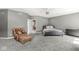 Bright main bedroom with sitting area, neutral walls, carpet, and ceiling fan at 7259 Josiah Ct, Indianapolis, IN 46259
