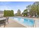 Backyard pool area offering lounge chairs, outdoor dining, and a peaceful atmosphere for relaxation and entertainment at 7259 Josiah Ct, Indianapolis, IN 46259