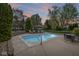 In-ground pool in a backyard with a patio, lounge chairs, and an umbrella at 7259 Josiah Ct, Indianapolis, IN 46259