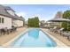 Inviting backyard pool area with lounge seating, mature landscaping, and outdoor dining space on a sunny day at 7259 Josiah Ct, Indianapolis, IN 46259
