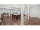 Spacious recreation room featuring a pool table, bar stools, accent columns, and wood-look floors at 7259 Josiah Ct, Indianapolis, IN 46259