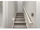 Carpeted stairs with gray walls and a white handrail at 7259 Josiah Ct, Indianapolis, IN 46259