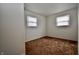 Bedroom featuring neutral walls, two windows for natural light, and carpet flooring at 7367 Parkside Dr, Indianapolis, IN 46226