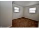 Bedroom featuring neutral walls, two windows for natural light, and carpet flooring at 7367 Parkside Dr, Indianapolis, IN 46226