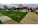 Cozy single-story home with a convenient driveway leading to a detached garage at 7367 Parkside Dr, Indianapolis, IN 46226