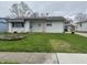 Modest single-story home with tidy lawn and neutral siding, and visible house number at 7367 Parkside Dr, Indianapolis, IN 46226
