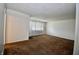 Spacious living area filled with natural light, enhancing the cozy carpeted floor at 7367 Parkside Dr, Indianapolis, IN 46226