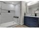 A beautifully renovated bathroom with a sleek shower, stylish vanity, and modern fixtures at 7783 Park N Ct, Indianapolis, IN 46260
