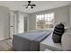 This bedroom has neutral paint, a ceiling fan, and a large window, creating a bright, airy space at 7783 Park N Ct, Indianapolis, IN 46260