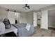 A bedroom features a sliding barn door, wood-look floors, and a ceiling fan for modern style at 7783 Park N Ct, Indianapolis, IN 46260