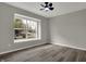 This bedroom offers neutral paint, a ceiling fan, and a large window, creating a bright, airy space at 7783 Park N Ct, Indianapolis, IN 46260