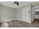 Bedroom featuring wood-look flooring, closet with sliding doors, and a ceiling fan at 7783 Park N Ct, Indianapolis, IN 46260