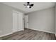 Bedroom featuring wood-look flooring, closet with sliding doors, and a ceiling fan at 7783 Park N Ct, Indianapolis, IN 46260