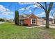 Charming brick home featuring a well-kept lawn and a welcoming entrance at 7783 Park N Ct, Indianapolis, IN 46260